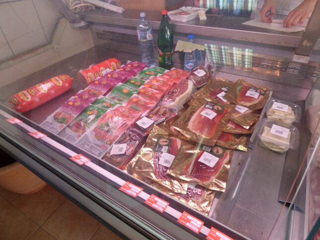 Prsut on a counter in a meat shop